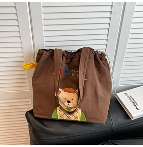Detail of embroidered bear and Sleeppe text on a brown canvas tote bag with drawstring