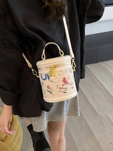 Graffiti bucket vanity bag in beige featuring colorful star and strawberry patterns