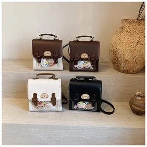 Detail of four colorful vintage British style mini Ita Bags with clear windows and puppy patch