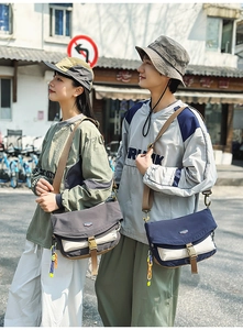 Detail of the nylon crossbody messenger bags featuring contrast colors and buckle closures