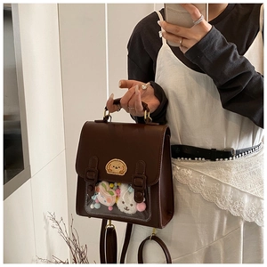Detail of vintage coffee backpack with clear window and cute plush interior accessories