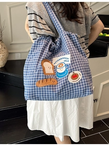 Blue checkered canvas tote bag with afternoon tea embroidery and drawstring closure