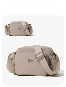 Dettaglio della borsa a tracolla grigia in nylon multitasche con ampia tracolla regolabile