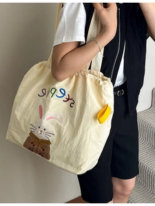 Large capacity canvas tote bag with cartoon rabbit embroidery and drawstring closure