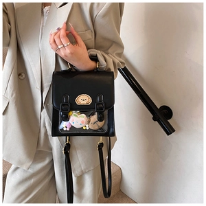 Detail of black itabag with transparent PVC window and cute plush interior accessories