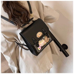 Detail of black PU leather backpack with transparent display window and cartoon embroidery