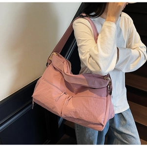 Pink large-capacity nylon crossbody bag with dual front zipper pockets and wide strap