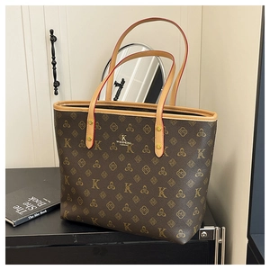 Detail of coffee tote bag with golden letter pattern and premium leather handles