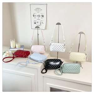 Detailed collection of polka dot crossbody bags in seven colors with pearl bow charms
