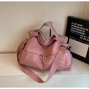 Pink large capacity nylon tote bag with dual front zippers and wide shoulder strap