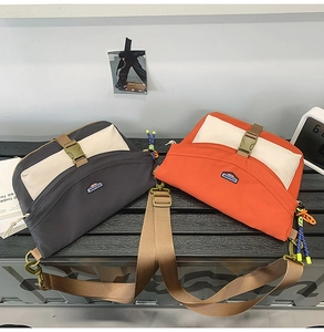 Detail of color-block nylon messenger bags with buckle closures and wide straps