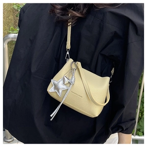Close-up of litchi texture bucket bag featuring FASHION & BAGS logo and star pendant