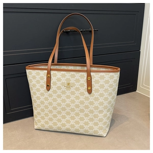 Detail of WEIDENG tote bag showing khaki monogram canvas and leather handles with gold rivets
