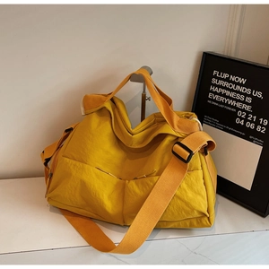 Detail of the bright yellow large capacity tote bag featuring wide adjustable shoulder straps