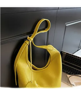 Detail view of the yellow leather Hobo bag with adjustable strap and side pleat detail
