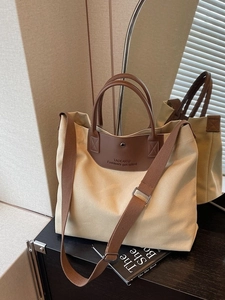 Large capacity off-white canvas tote bag with brown leather handles for women's daily commute