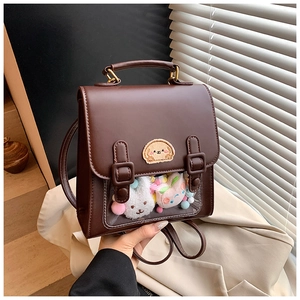Detail of dark brown PU leather backpack with clear window and cartoon bear embroidery