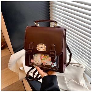 Close-up of brown PU leather ita bag with clear PVC window and cute embroidery