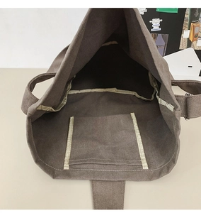Macro view of the spacious canvas tote bag interior showing the functional inner pocket