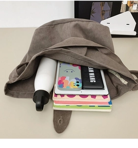 Interior view showing large capacity for tablet, water bottle and books in canvas tote