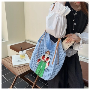 Detailed knit tote bag featuring retro cartoon girl embroidery and brown leather straps