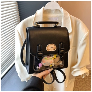 Detail view of black commuter backpack with transparent window and cartoon dog embroidery