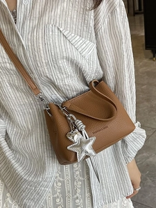 Brown litchi texture bucket bag with silver charms and adjustable crossbody strap