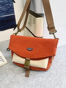 Orange nylon crossbody messenger bag with off-white pocket and tactical buckle strap