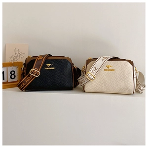 Detail of Boston pillow bags in black and beige with wide woven straps and gold hardware
