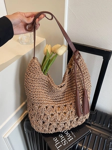 Retro straw woven tote bag with fringe tassel and leather straps for beach vacation