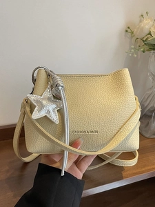 Minimalist light yellow lychee grain leather bucket bag with silver star charm decoration