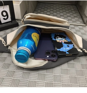 Top view of the spacious main compartment showing storage for a phone and 500ml bottle