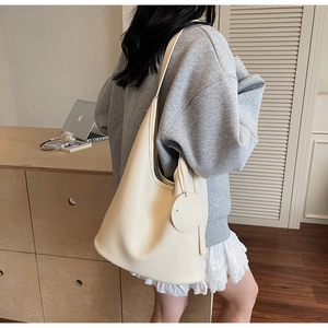 Minimalist beige leather tote bag with lychee texture and round coin purse detail