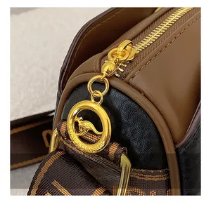 Macro detail of the golden ring zipper pull and premium lychee texture on Boston bag