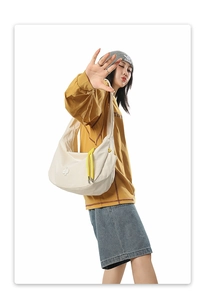 Detail of checkered crescent bag with yellow drawstring and star logo on white canvas