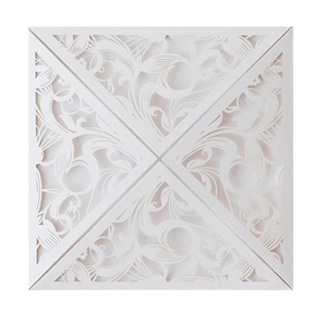 Detailed laser-cut white wedding invitation cover with intricate floral lace patterns