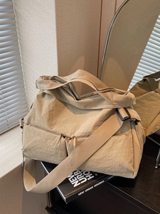 Minimalist beige large capacity crossbody tote bag with wide strap and utility pockets