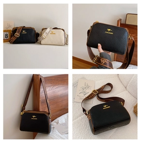 Detail of Boston pillow bag showing pebble leather texture and wide jacquard logo strap