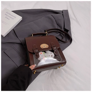 Detail of vintage brown PU leather bag with cute bread dog embroidery and clear PVC window