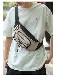 Detail of crossbody chest bag featuring adjustable strap buckle and bungee cord design