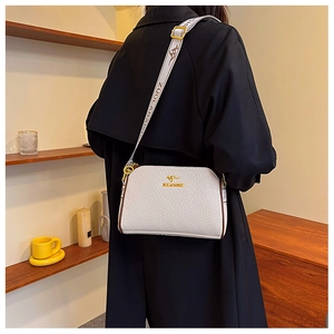 Detail of white leather crossbody bag with wide strap and golden kangaroo logo