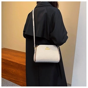 Detail of off-white lychee texture leather Boston bag with golden kangaroo logo and strap