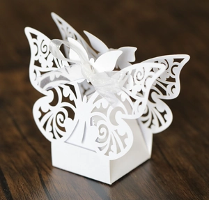 Elegant laser-cut white butterfly candy box with silk ribbon for weddings and parties