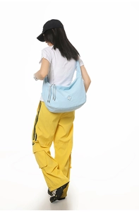 Close-up of light blue waffle texture crossbody bag with side drawstring details