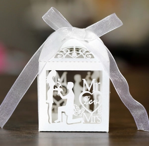 Detailed laser-cut wedding favor box with Love lettering and white organza ribbon