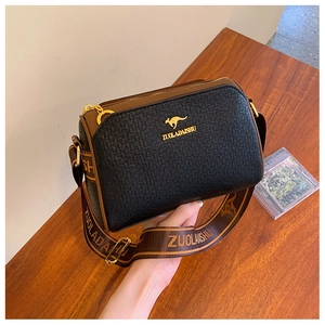 Close-up of leather Boston bag with brand logo and stylish woven shoulder strap