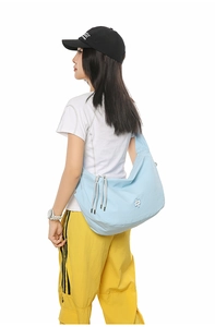 Blue gingham hobo bag featuring grey drawstring details and large capacity shown on model