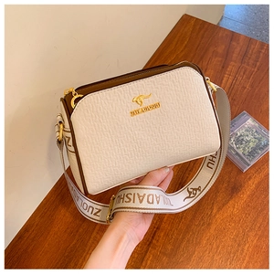 Detail of lychee pattern white PU leather handbag with gold kangaroo logo and strap