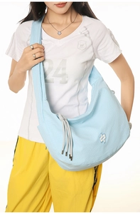 Detail of light blue checkered crescent bag with adjustable grey drawstrings and logo