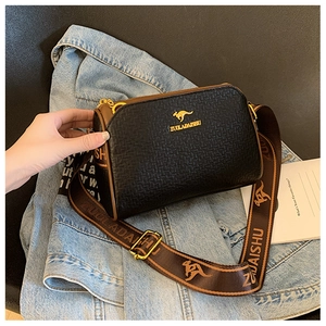 Close-up of black textured Boston bag with golden kangaroo logo and wide woven strap